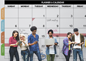 People in front of a billboard size calendar
