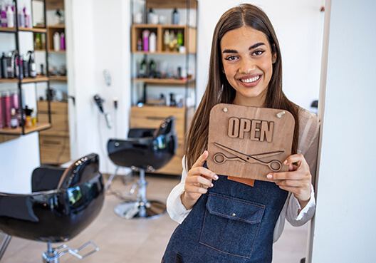 A female business owner stands in her beauty salon. 