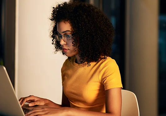 Woman typing on a laptop