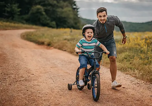 A man supported financially by disability insurance spends time outdoors with his dog. A South African man enjoys spending time outside with his dog.