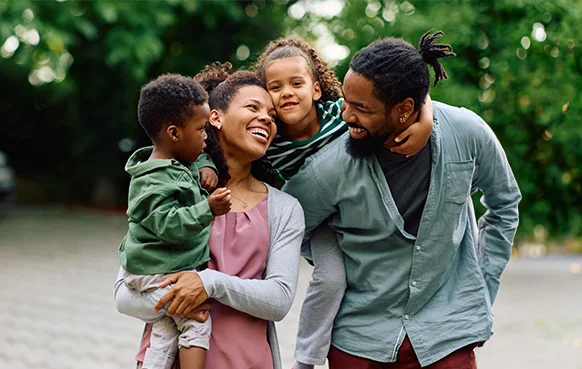A South African couple spend time with their two young children outdoors. 