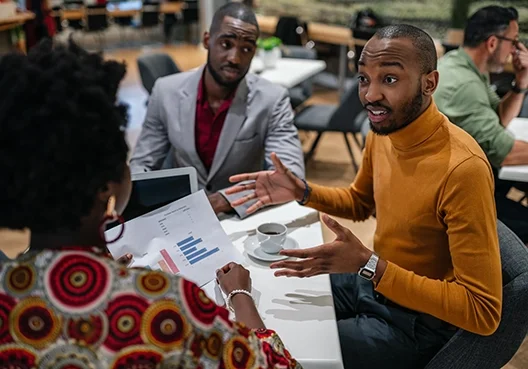 Young South Africans sitting in a coffee shop talking business