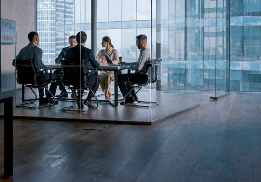 Asset managers attend a meeting to talk about investment news. 