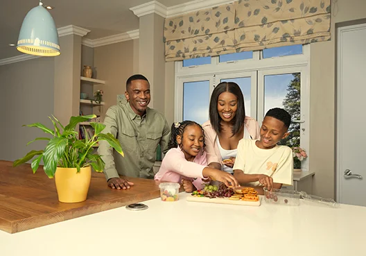A family of four enjoying a fruit together, feeling secure with a life cover in place.