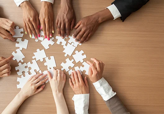 Call centre staff  at Old Mutual Insure build a puzzle consisting of white pieces.