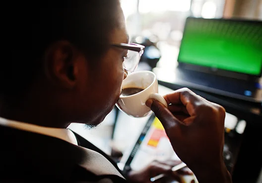 Man drinking coffee in an office