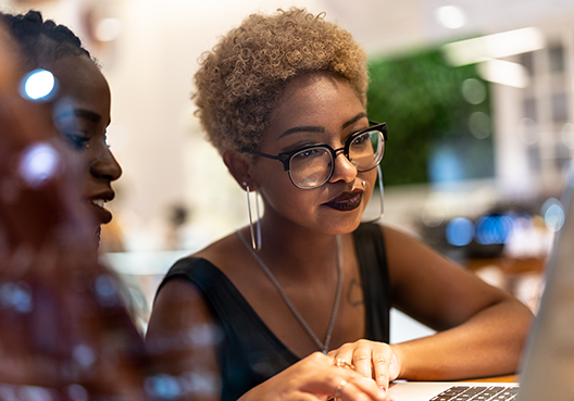 Two women looking at a laptop screen