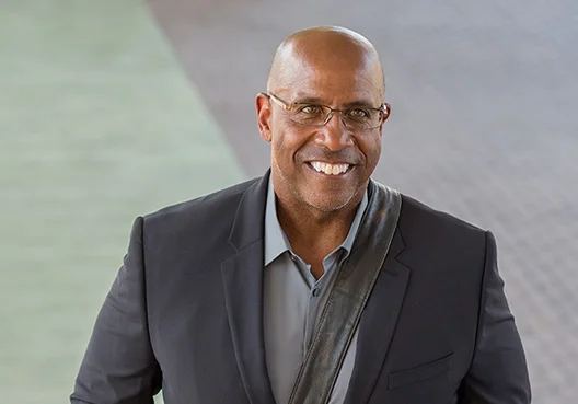 A South African man smiles on his way to meet with a financial adviser to discuss his retirement.