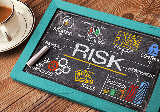 A handheld blackboard with information speaking to risk management. 