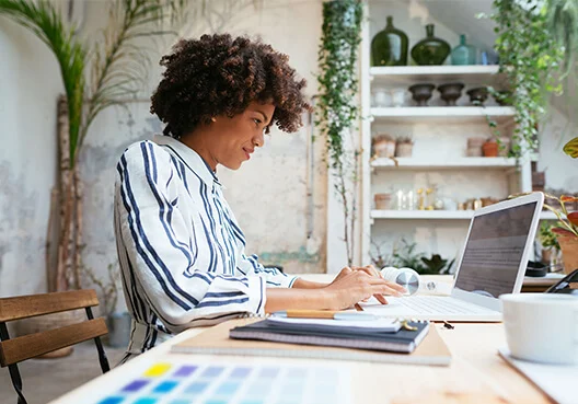 A woman checks her notes before attending a video interview.