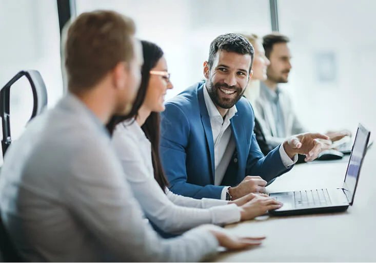 Business professionals meet to discuss the benefits of going in on a franchise together.