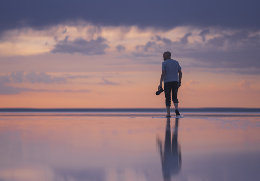 A man walking on the beach.