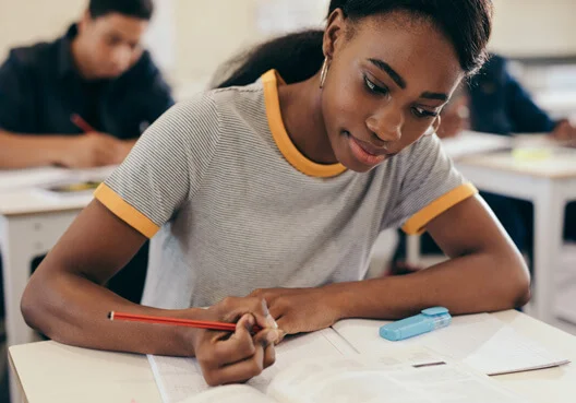A young South African woman works on a psychometric assessment for a potential bursary.