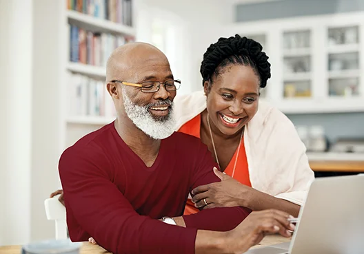 An older man looks up information related to living and guaranteed annuities online. 