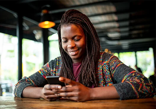 A woman practices answering interview questions using her phone to record and review.
