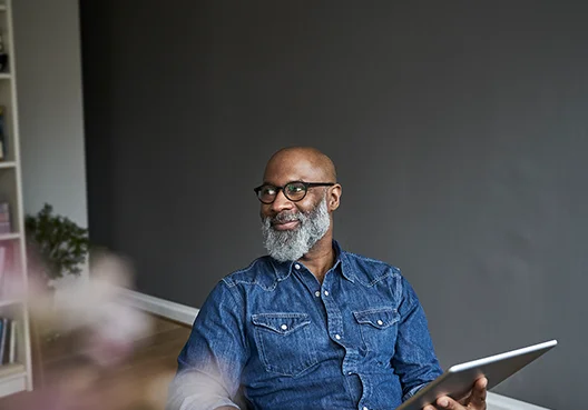 Man smiles with iPan in hand