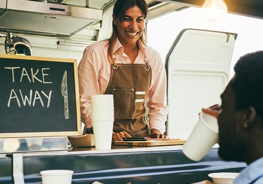 A customer buys a drink from a fast truck in South Africa