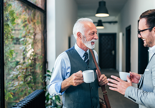 A financial planner chats to his elderly client about his investments.