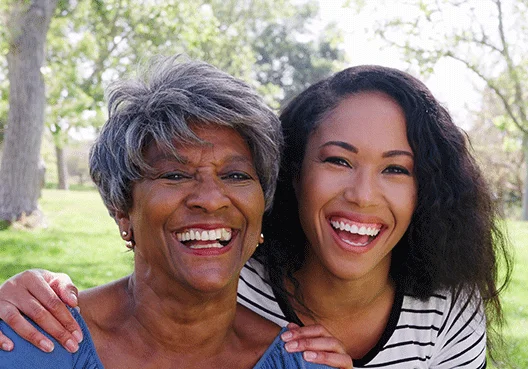 An older woman enjoys time with her daughter, knowing that she has enough saved for retirement to be comfortable.