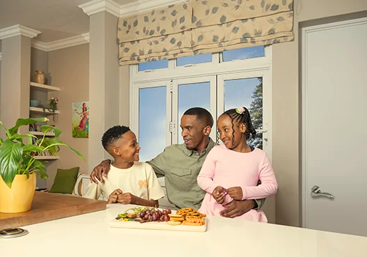 Dad and Kids Enjoy Fruit Together in the Kitchen of Their New Home