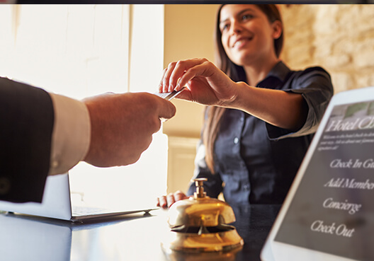 A guest at a hotel pays for his stay with a credit card. 