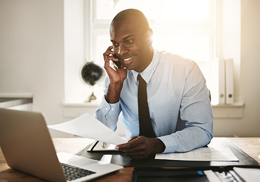 A lawyer who owns his own legal practice checks his business insurance policy. 