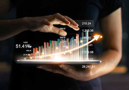 Numbers, formulas, and graphs emerging from a tablet being held from a person.