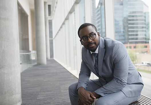 Man in formal wear sitting on a bench