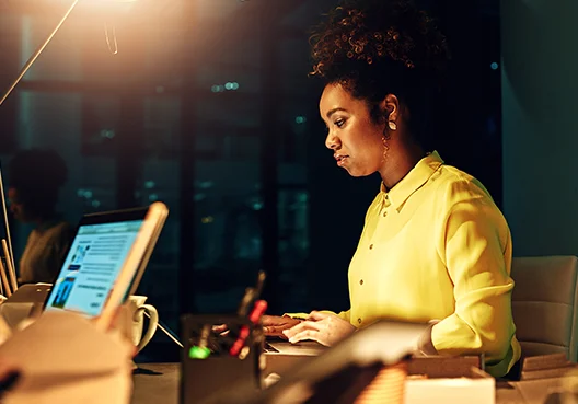 A woman sitting in her office gets in touch with Old Mutual Corporate’s Intermediary Consultants. 