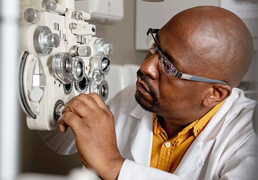 An optometrist does a check of his equipment at his practice.