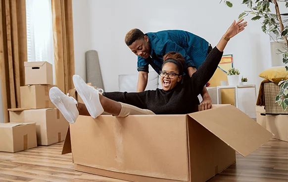 A South African couple unpack in their lounge after moving into a new house.