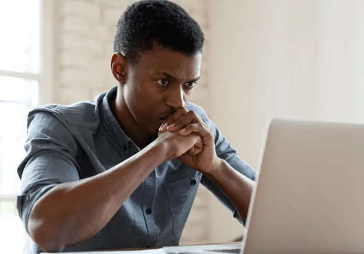 A South African student uses his computer to research common interview questions.